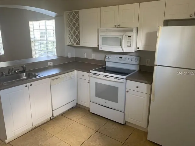 a kitchen with a stove a sink and a refrigerator
