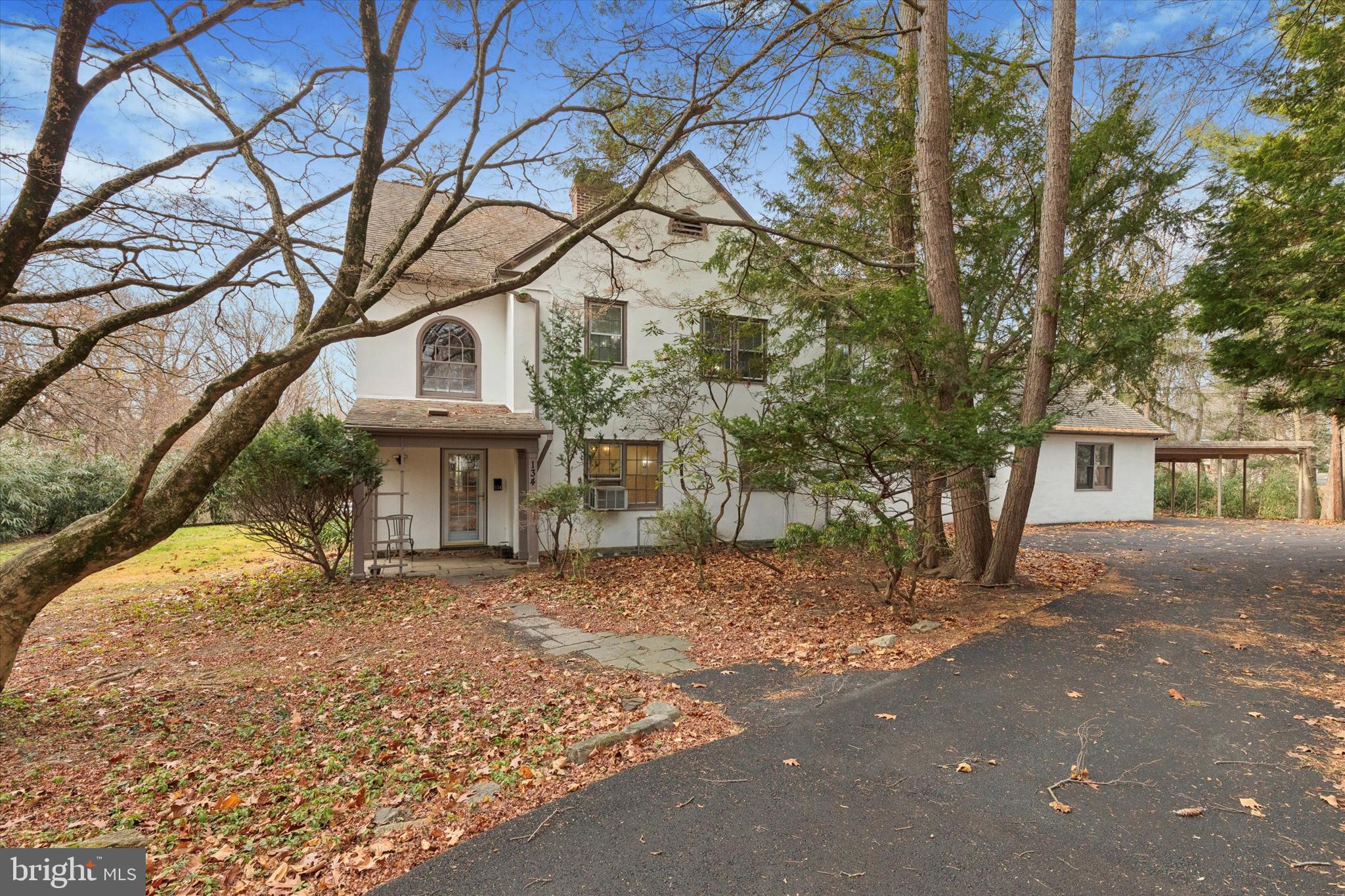 Driveway view of the house w/ carport to the side
