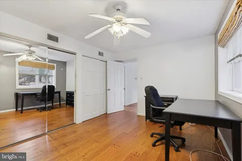 a workspace with wooden floor and a window