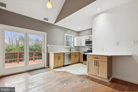 a open kitchen with granite countertop a stove top oven sink and cabinets