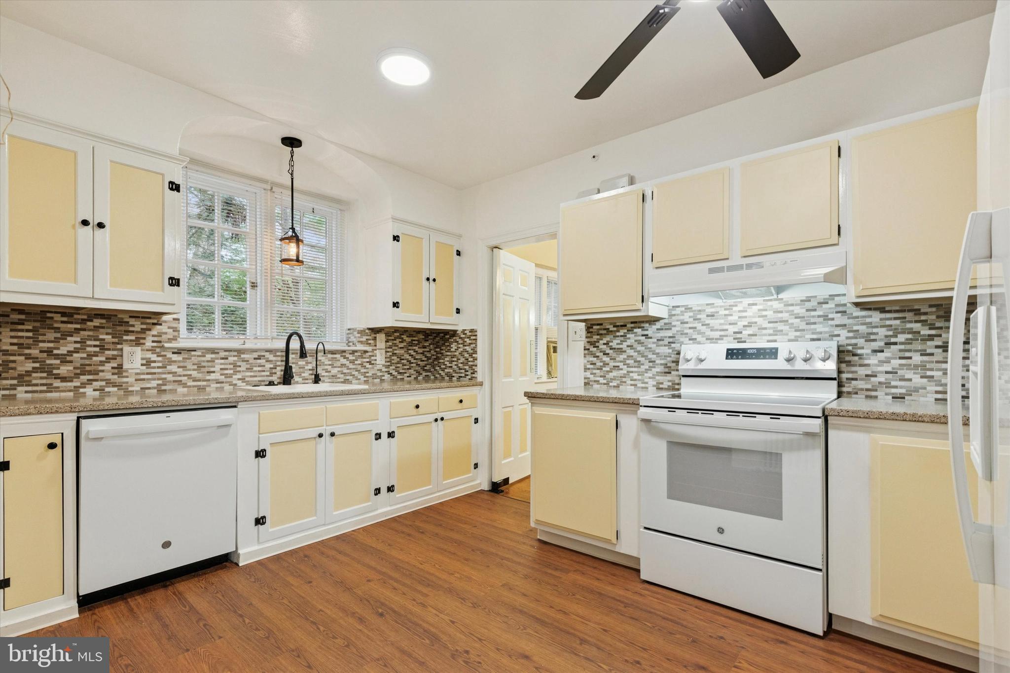 134 Yew Road Cheltenham, PA 19012 - Photo 2 of 19 a kitchen with granite countertop white cabinets and white appliances