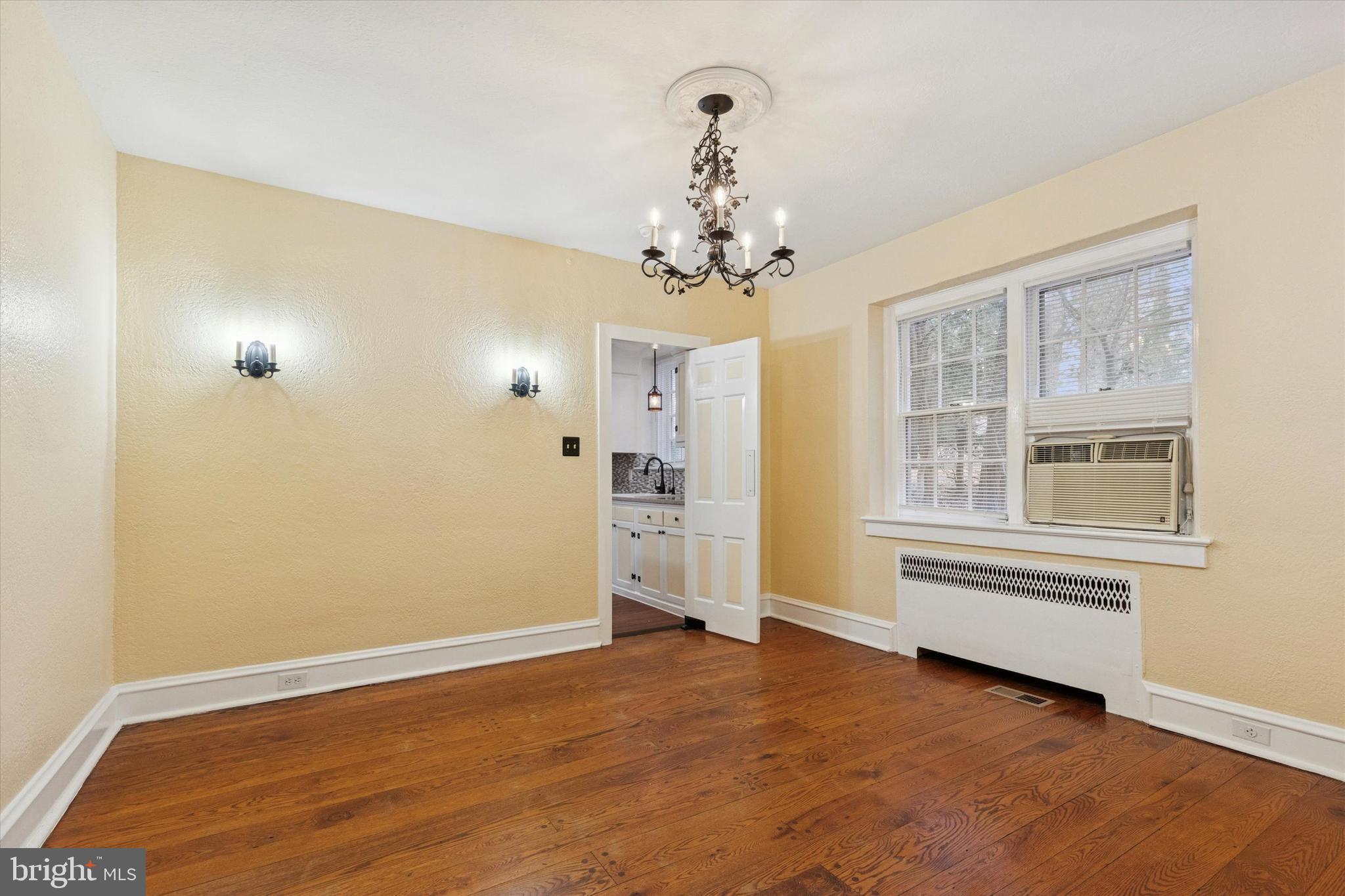 134 Yew Road Cheltenham, PA 19012 - Photo 3 of 19 an empty room with a windows and chandelier fan