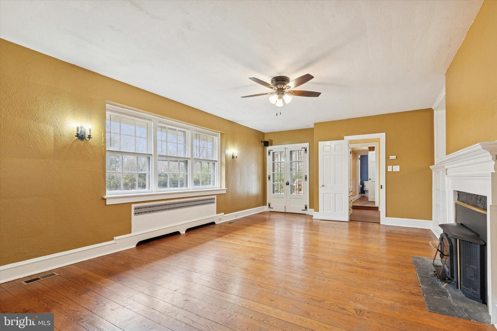 134 Yew Road Cheltenham, PA 19012 - Photo 4 of 19 a view of an empty room with a window and wooden floor
