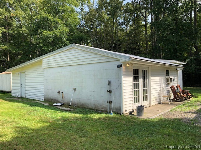 460 Holly Point Road Mathews, VA 23109 - Photo 7 of 16 a backyard of a house with yard and seating area