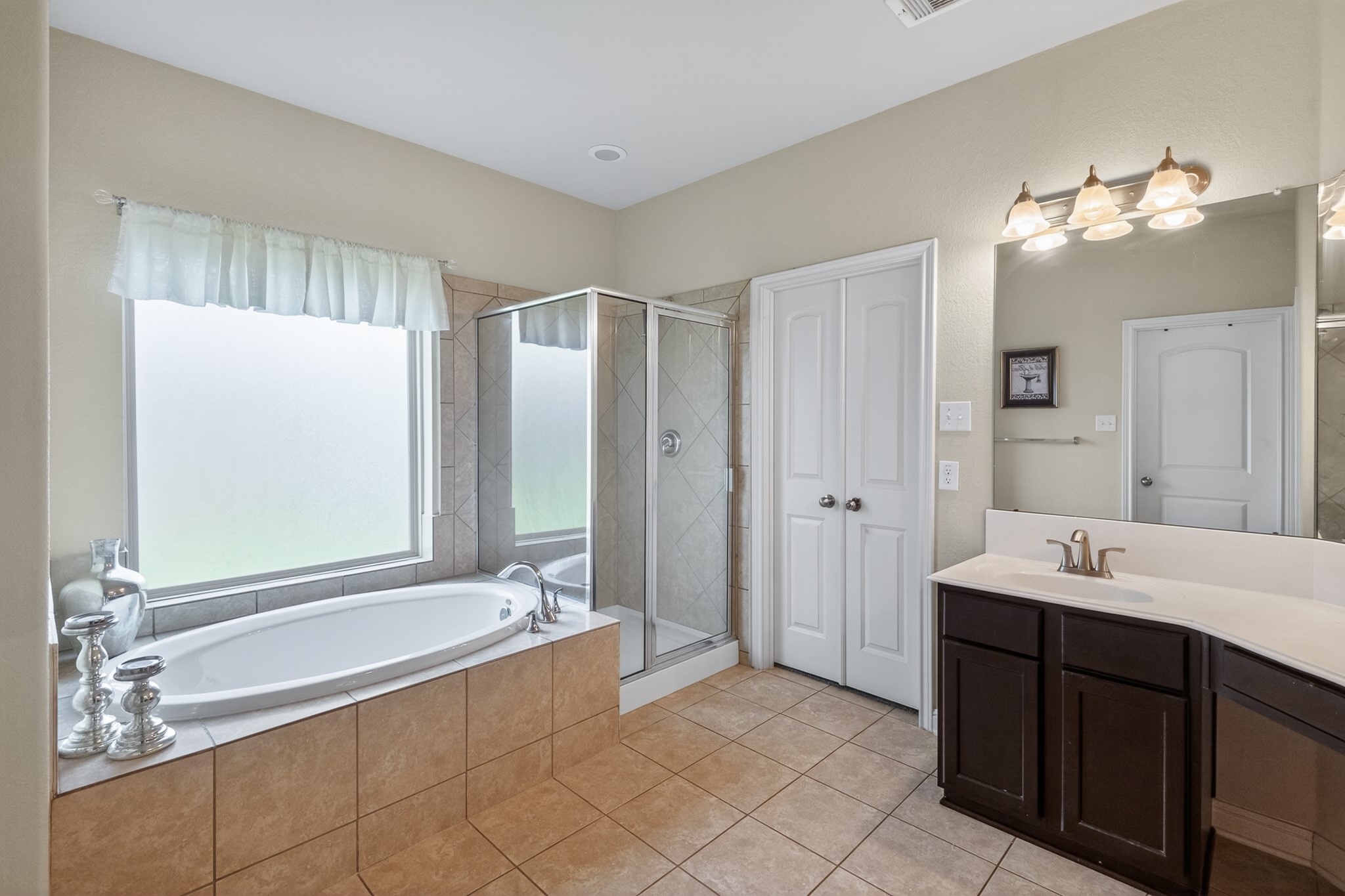 24711 East Burnaby Circle Spring, TX 77373 - Photo 13 of 20 a spacious bathroom with a double vanity sink mirror and shower