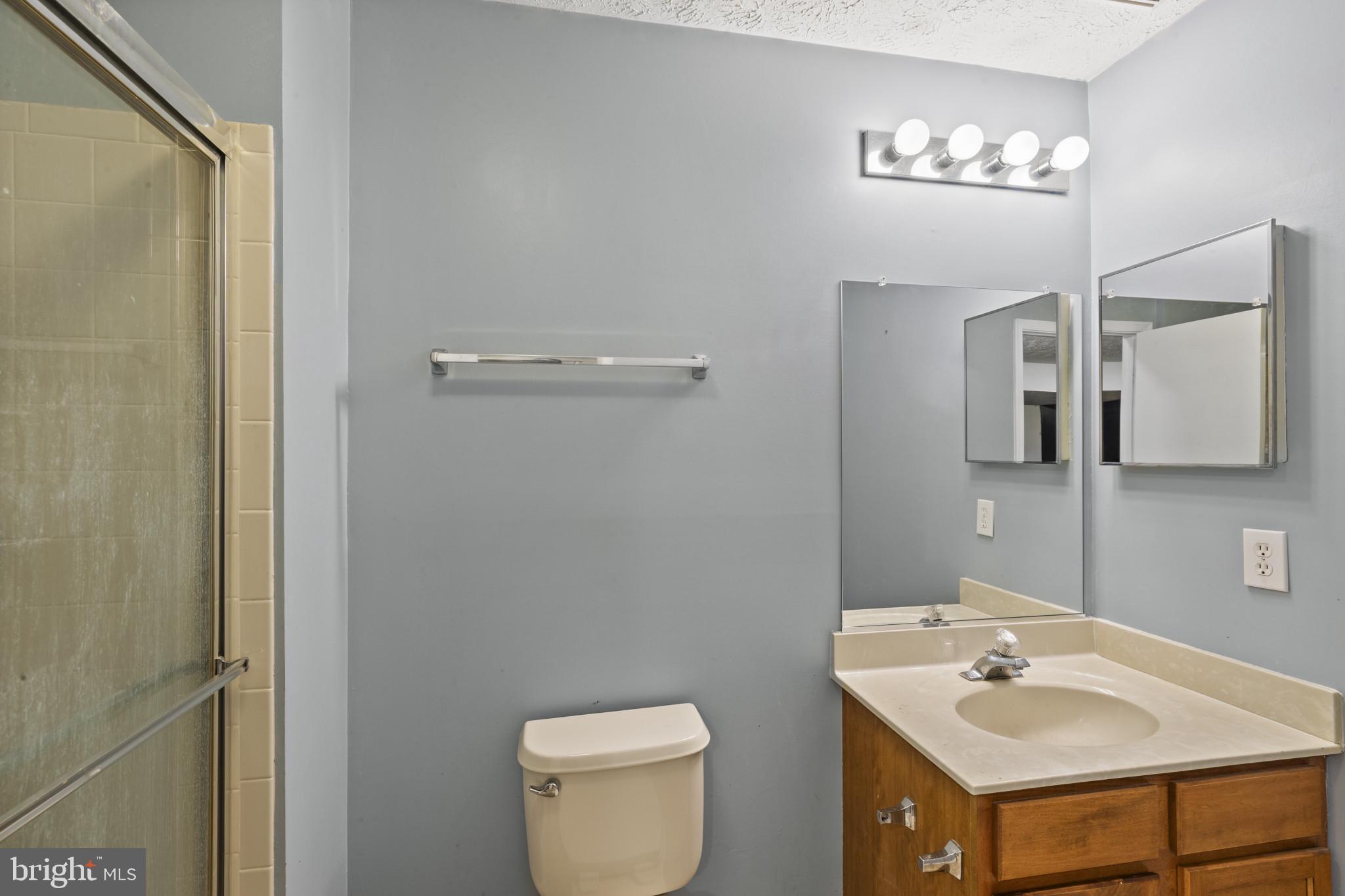 2042 Hackberry Road Baltimore, MD 21221 - Photo 12 of 26 a bathroom with a sink toilet and mirror