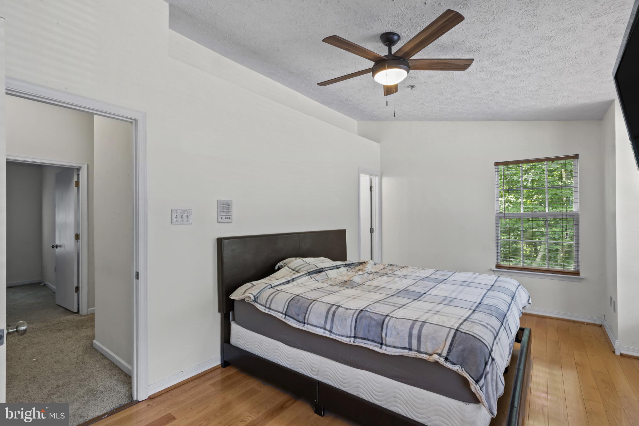 2042 Hackberry Road Baltimore, MD 21221 - Photo 20 of 26 a bedroom with a large bed and a ceiling fan