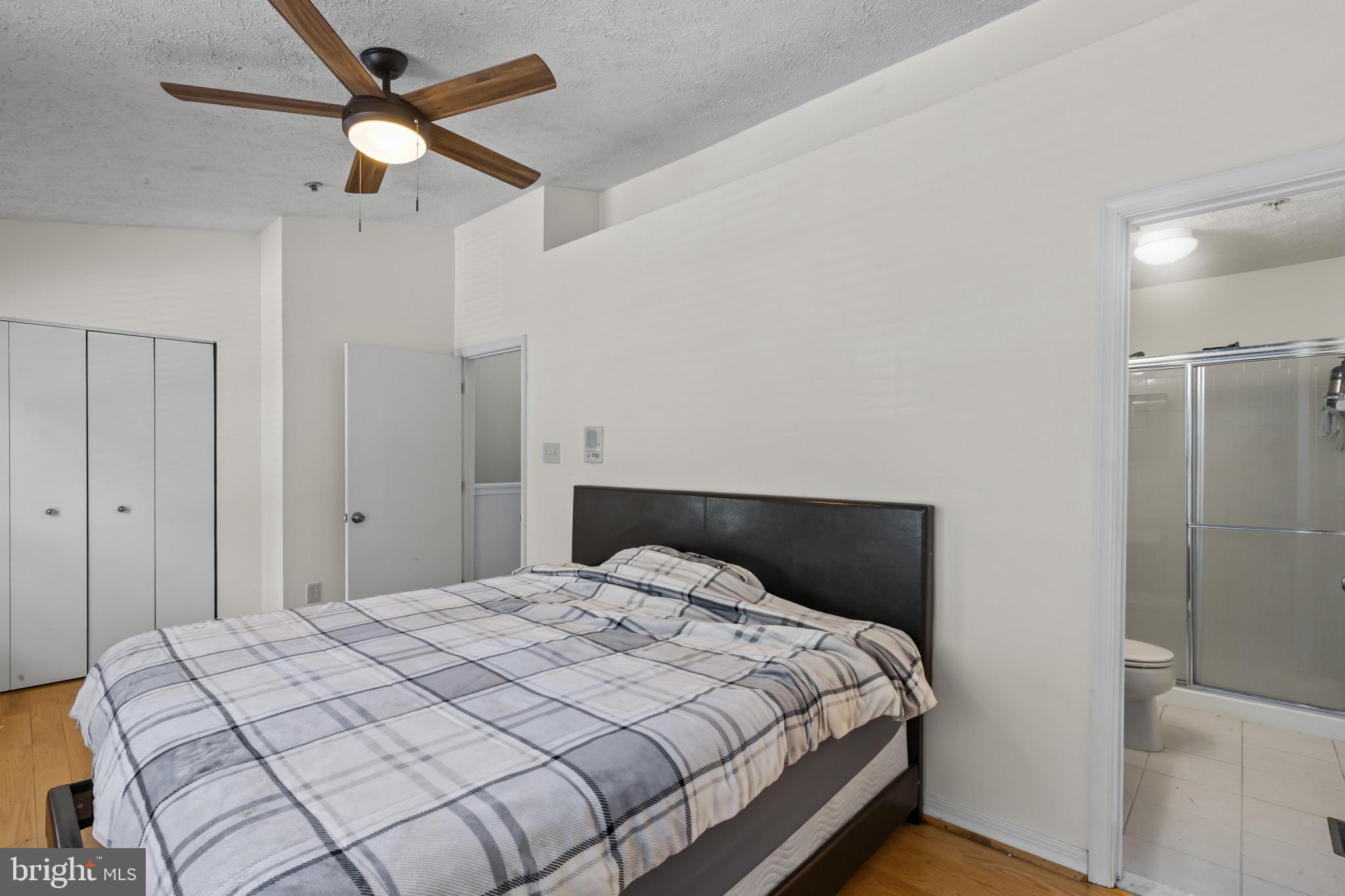 2042 Hackberry Road Baltimore, MD 21221 - Photo 22 of 26 a bedroom with a bed and a ceiling fan
