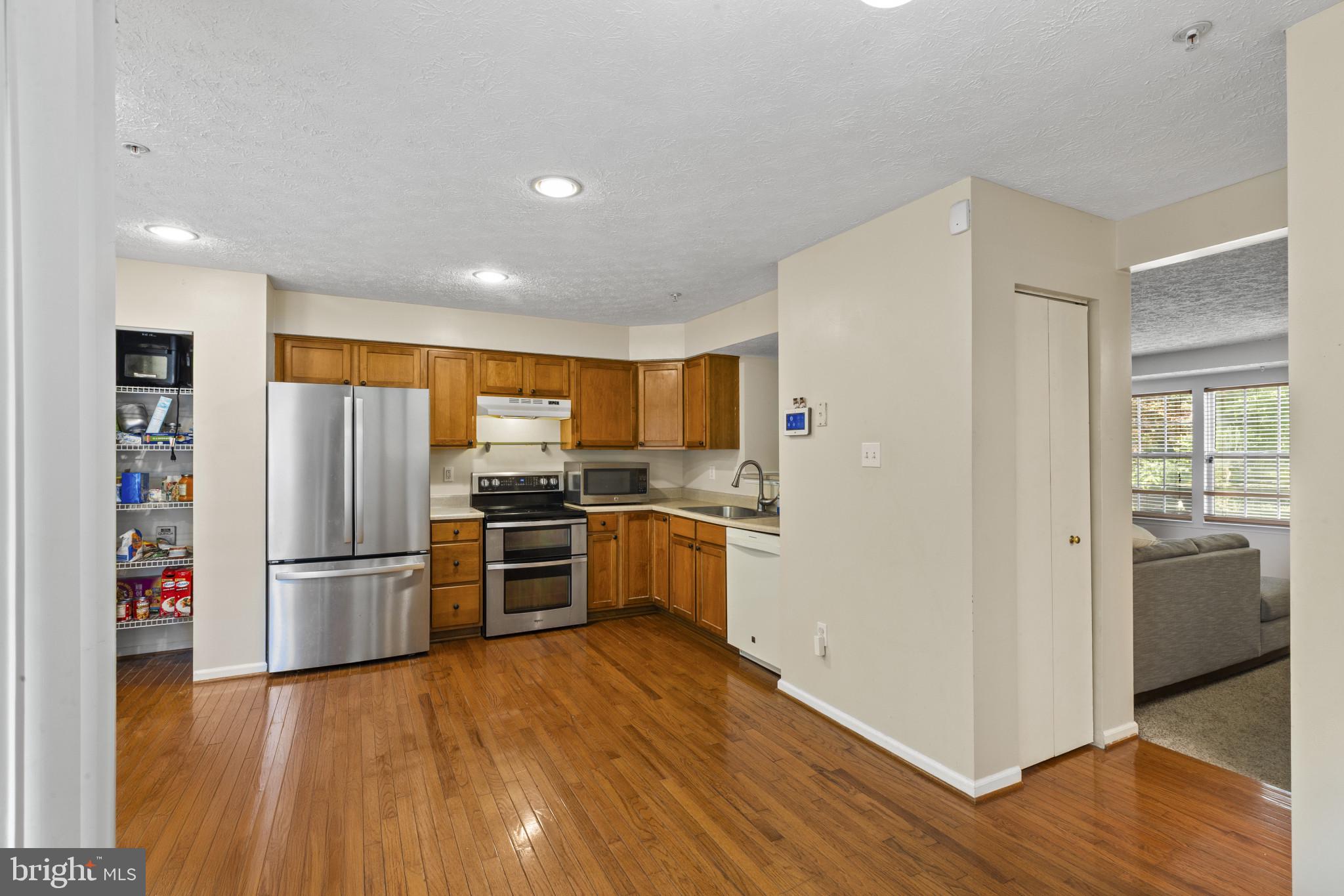 2042 Hackberry Road Baltimore, MD 21221 - Photo 9 of 26 a kitchen with a refrigerator and a stove top oven