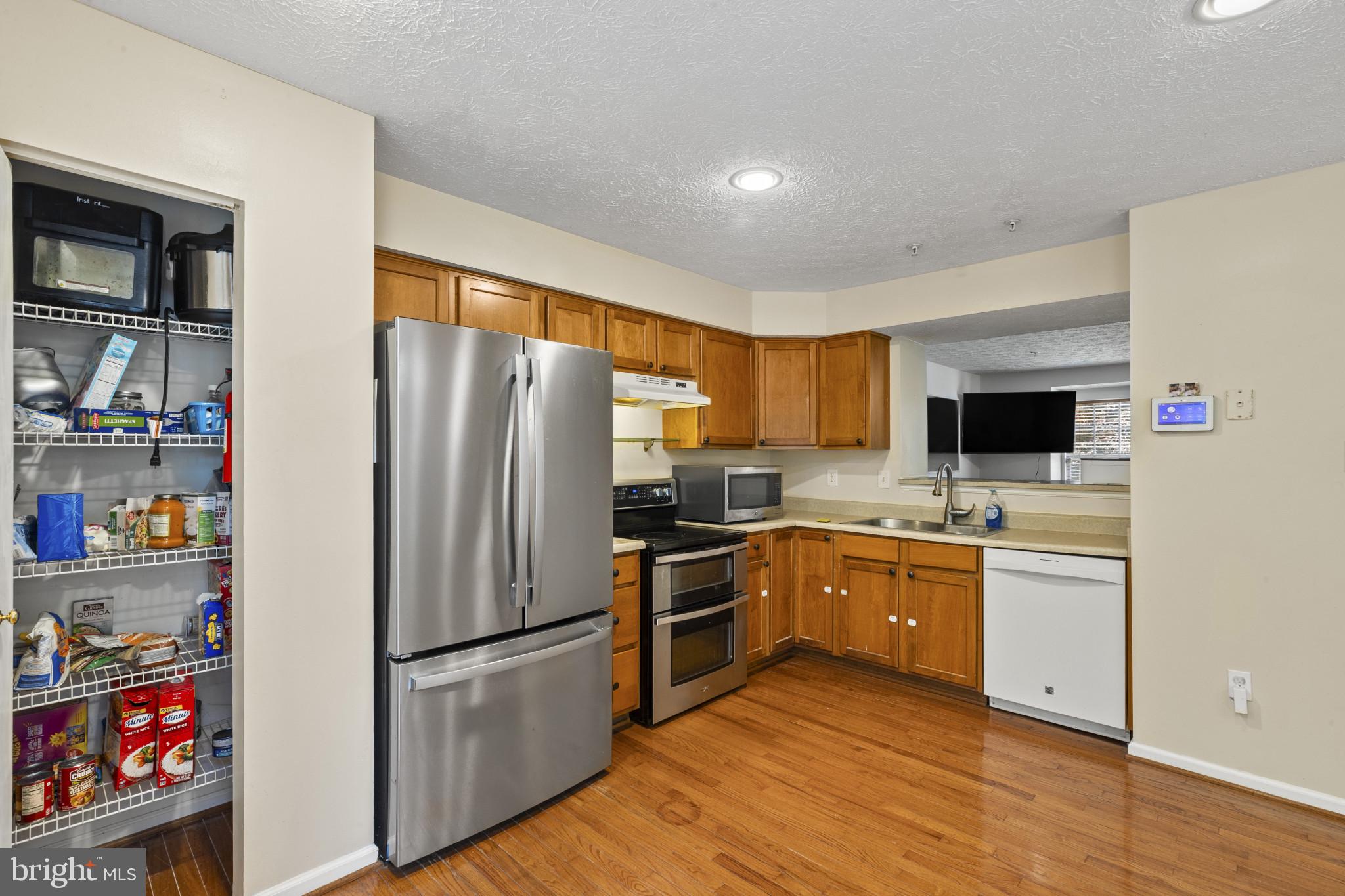 2042 Hackberry Road Baltimore, MD 21221 - Photo 10 of 26 a kitchen with stainless steel appliances a refrigerator a stove a sink and a refrigerator