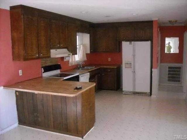 a kitchen with stainless steel appliances granite countertop a stove a refrigerator and a refrigerator