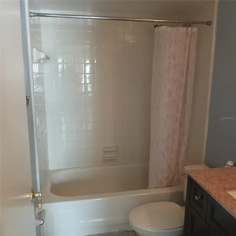 a bathroom with a shower and a toilet