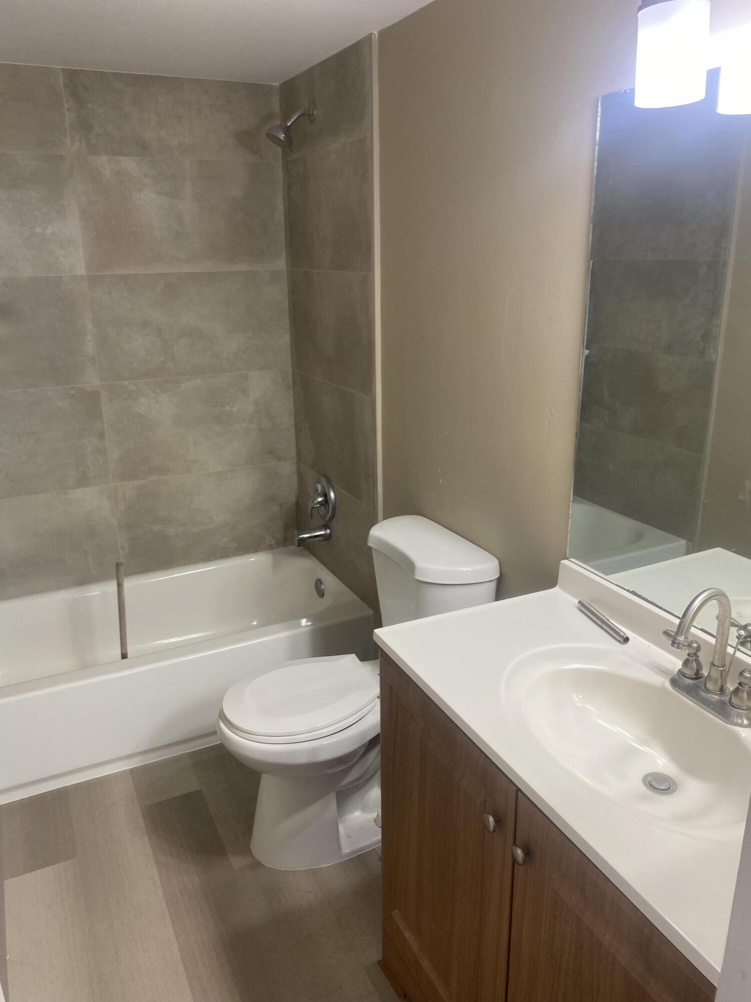 2181 Woolbright Road, Unit N201 Boynton Beach, FL 33426 - Photo 9 of 15 a bathroom with a sink toilet and shower