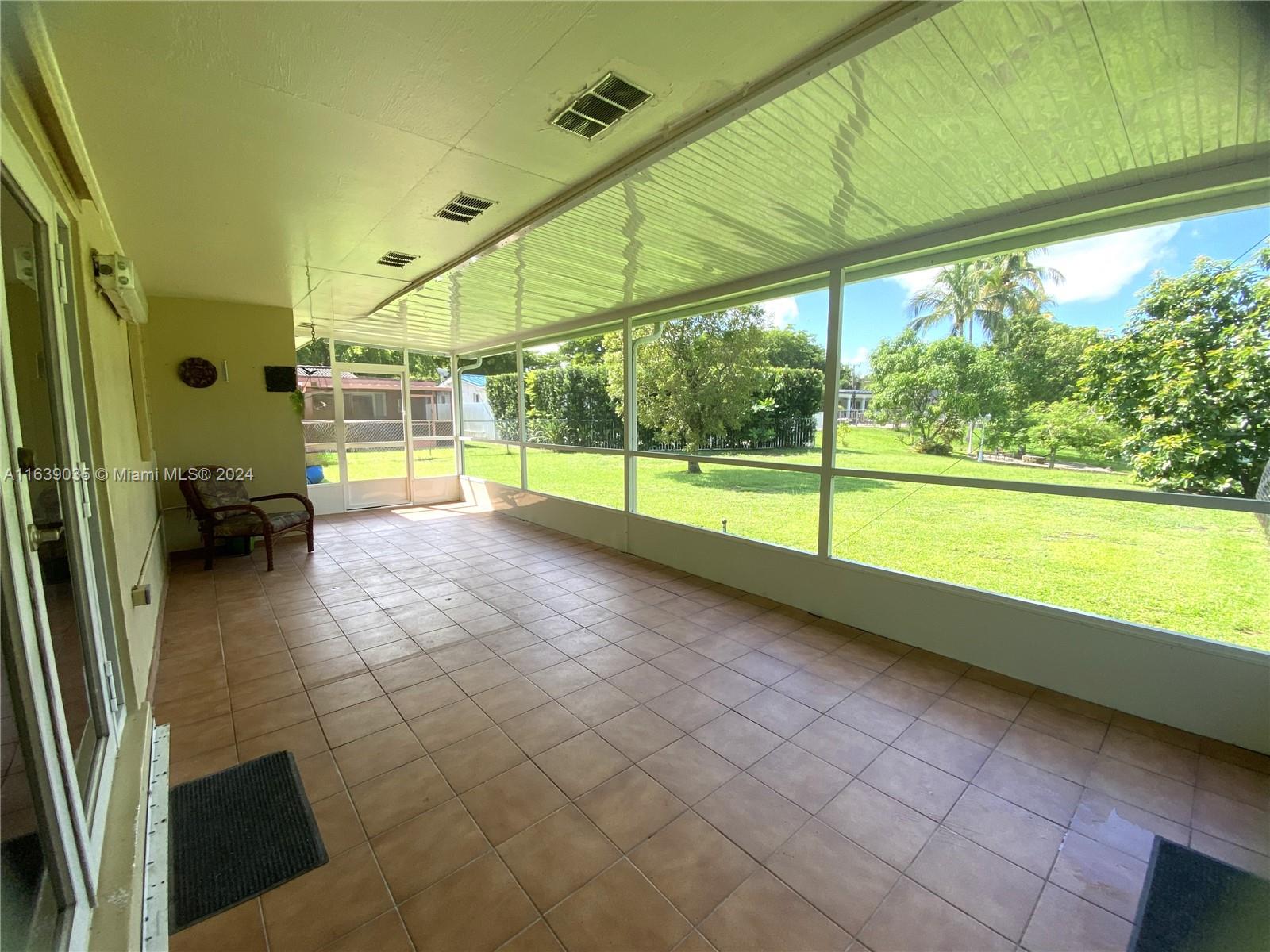 14550 English Road Miami Lakes, FL 33014 - Photo 19 of 33 Long view of spacious terrace, enjoy as is or convert to family room - there are endless possibilities !!