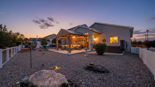 a view of a house with backyard and a garden