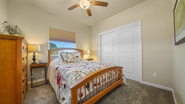 a bedroom with a bed and a chandelier