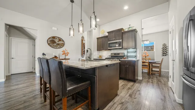 a view of kitchen with sink and refrigerator