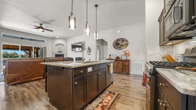 a kitchen with stainless steel appliances granite countertop a stove and a sink