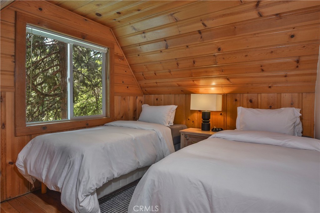761 Arrowhead Villa Road Lake Arrowhead, CA 92352 - Photo 18 of 31 a bed sitting in a bedroom next to a window
