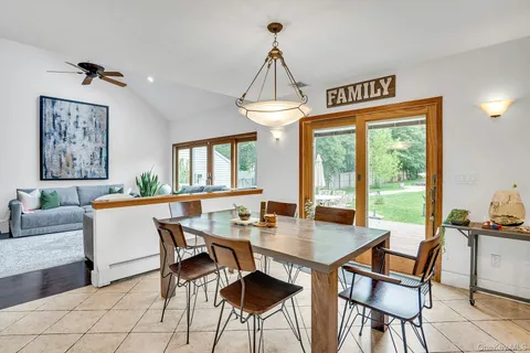 a view of a dining room with furniture and a chandelier