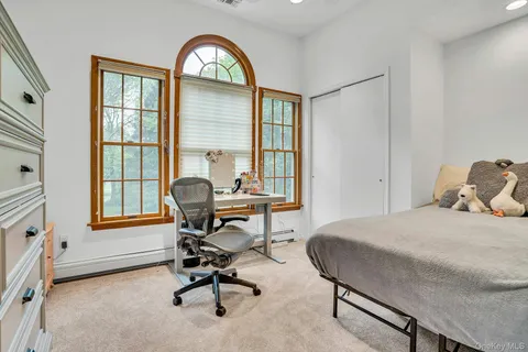 a spacious bedroom with a bed and a couch