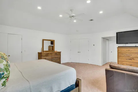 a bathroom with a double vanity sink mirror and toilet