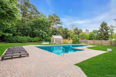 a view of yard with swimming pool and green space