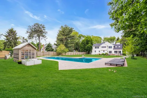 a view of a swimming pool with a yard