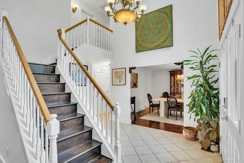 a view of staircase with lots of furniture and a chandelier