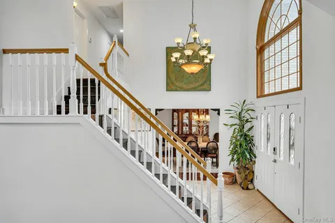 a living room with couches a dining table with wooden floor and furniture