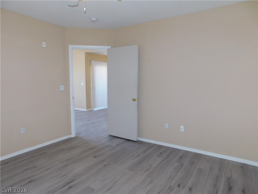 7255 West Sunset Road, Unit 2029 Las Vegas, NV 89113 - Photo 12 of 21 A spacious room features warm neutral walls and durable, wood-look flooring throughout.