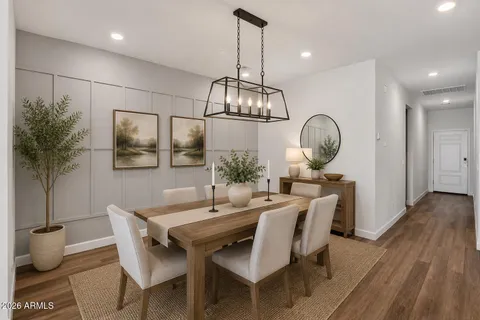 a view of a dining room with furniture a chandelier and wooden floor
