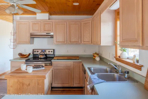 a kitchen with a sink a stove and cabinets
