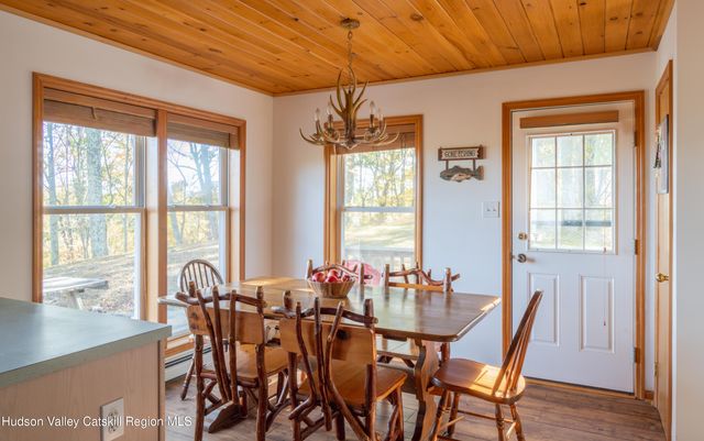 a view of a dining room with furniture window and outside view