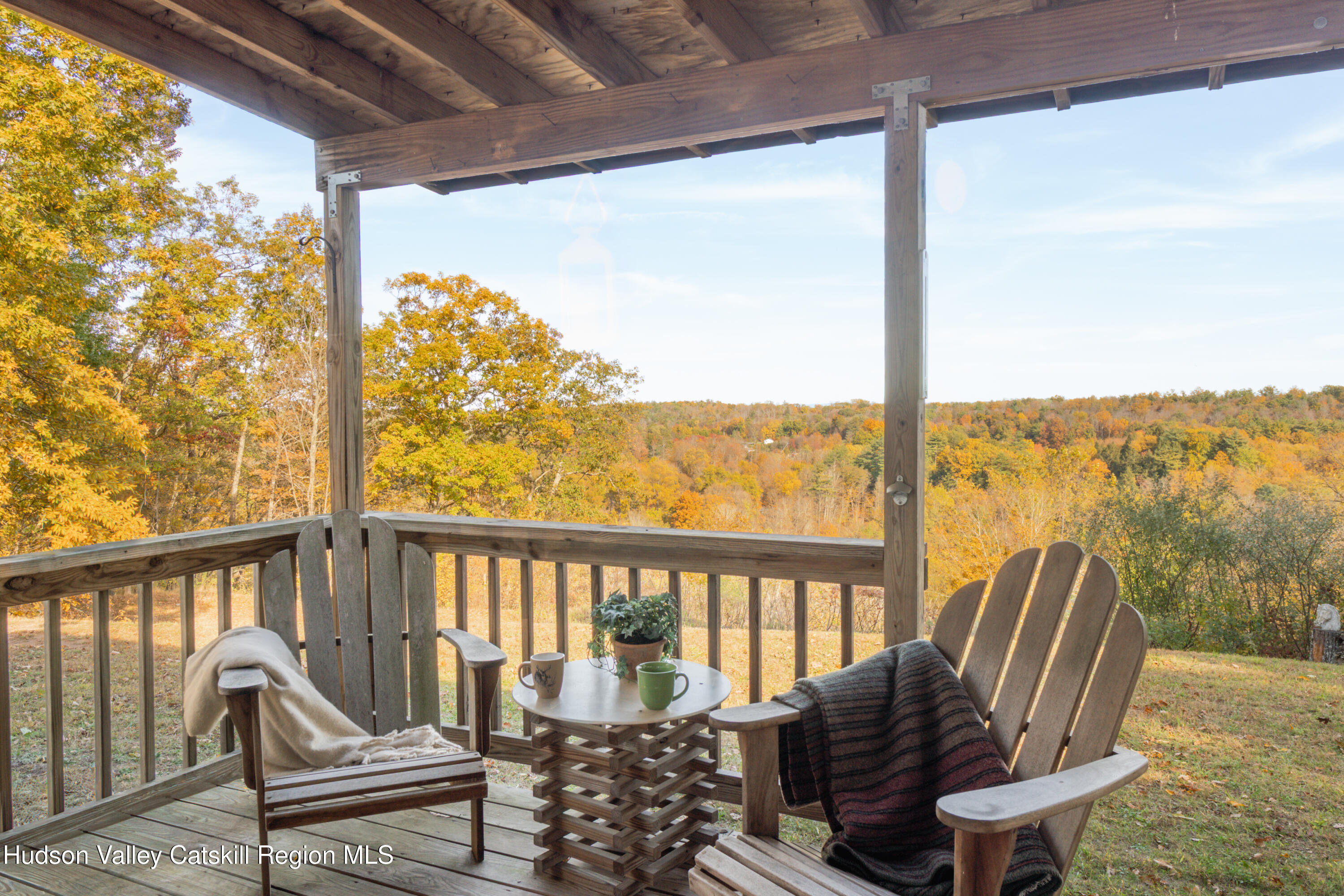 78 Ridge Way Catskill, NY 12414 - Photo 2 of 40 a view of a chair and table in the balcony