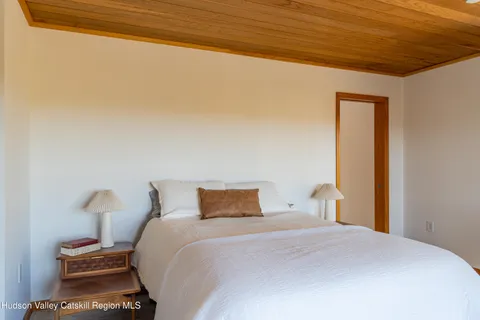 a bedroom with a bed and a night stand