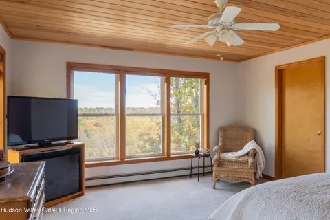a bedroom with furniture and a window