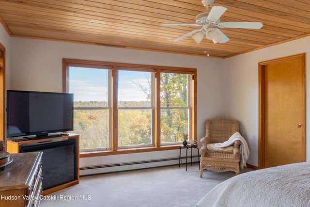 a bedroom with furniture and a window