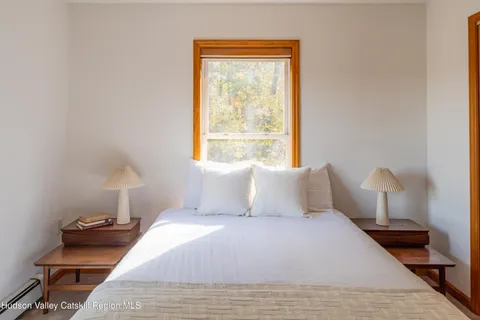 a bedroom with a bed and window