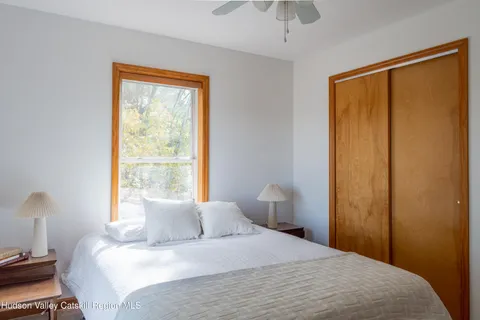 a bedroom with a bed and a window