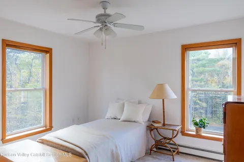 a bedroom with a bed a lamp and a window