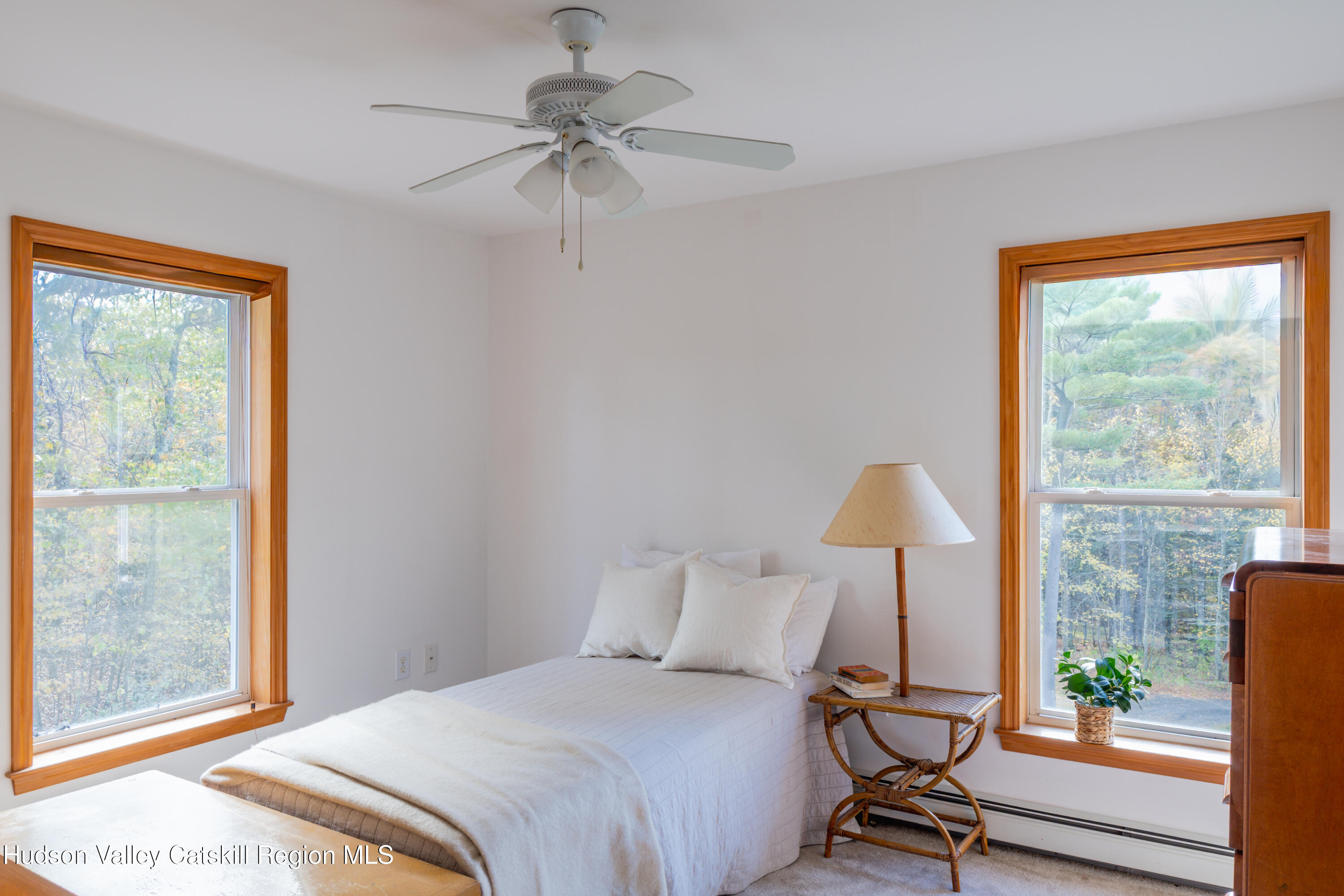 78 Ridge Way Catskill, NY 12414 - Photo 31 of 40 a bedroom with a bed a lamp and a window