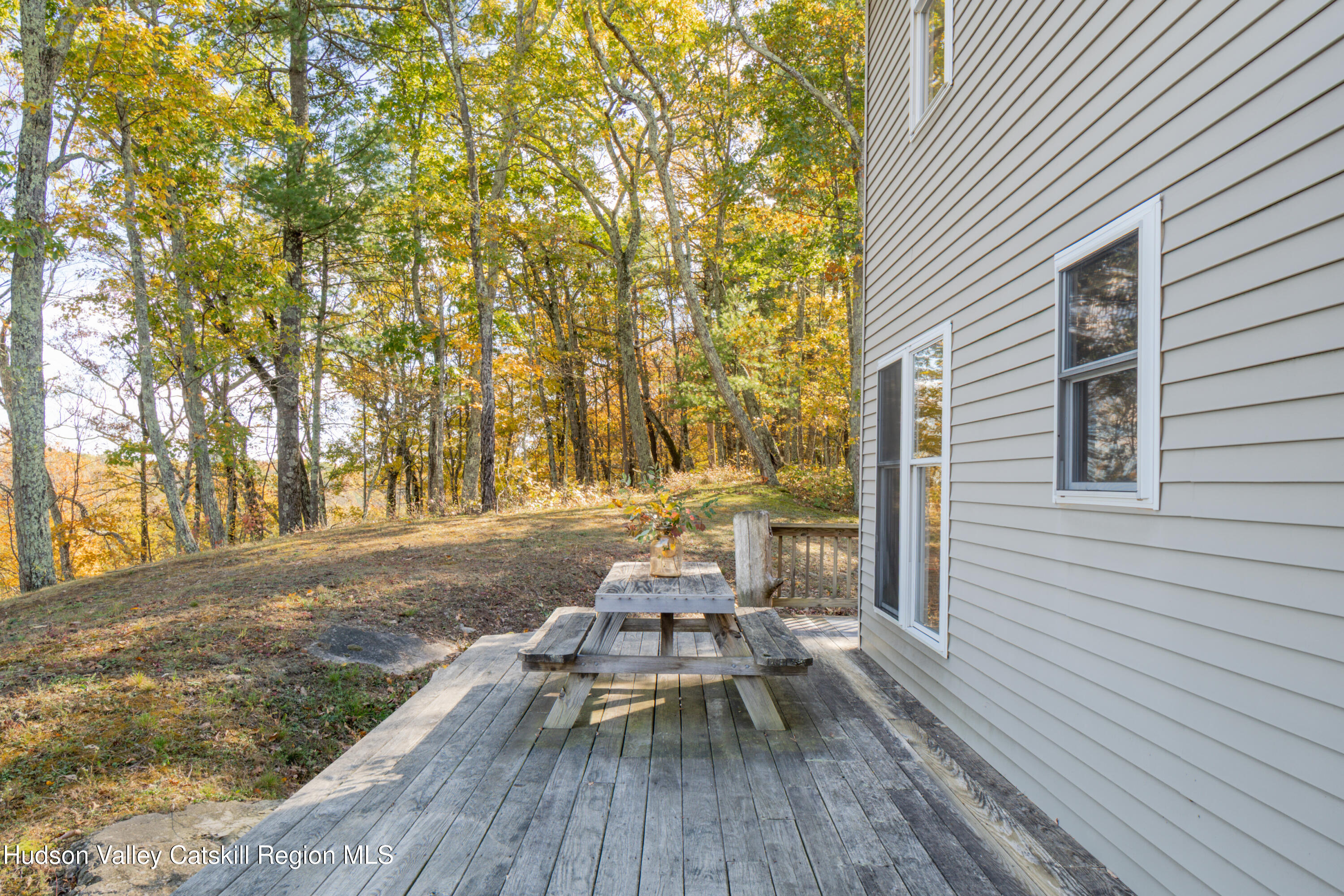78 Ridge Way Catskill, NY 12414 - Photo 34 of 40 a view of a patio with chairs and table on the wooden floor