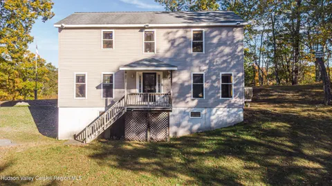 a view of a house with pool and sitting area