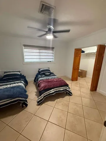 a bedroom with a bed and a ceiling fan