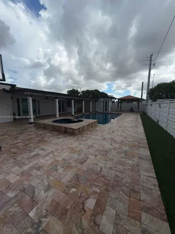 a view of a swimming pool with a yard