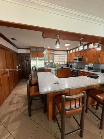 a large kitchen with a table and chairs