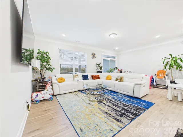 a living room with furniture and a rug