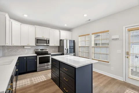 a kitchen with a stove a sink and a refrigerator