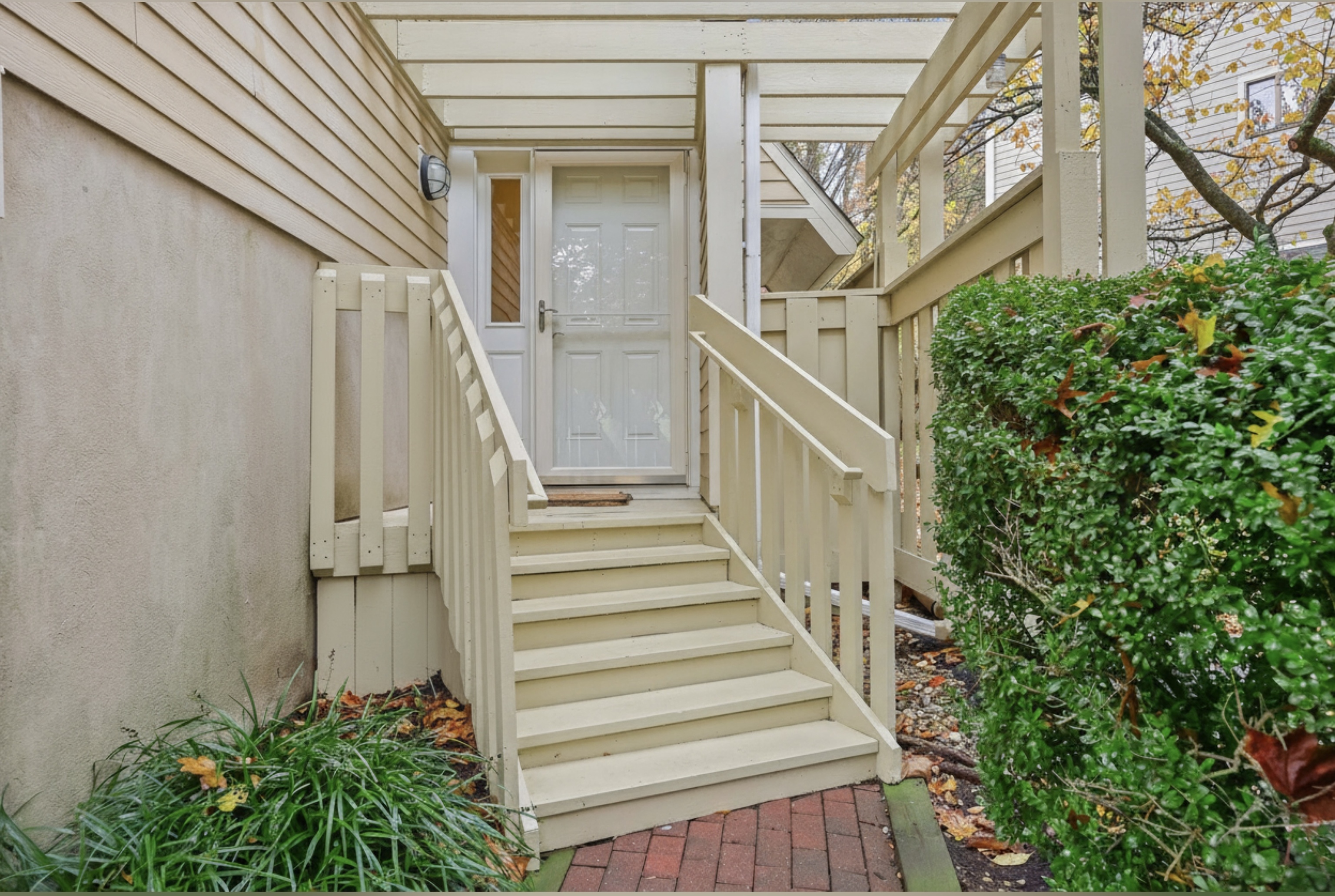 a view of a pathway of a house with potted plants
